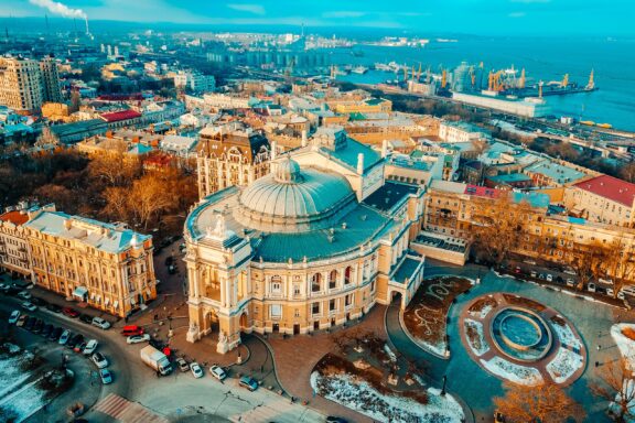 An aerial view of the city of Odessa and its Black Sea coastline in the distance.