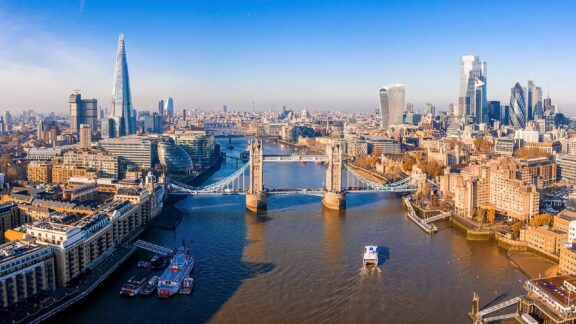 An aerial view of the Tower Bridge and surrounding city in London, the capital of the United Kingdom.