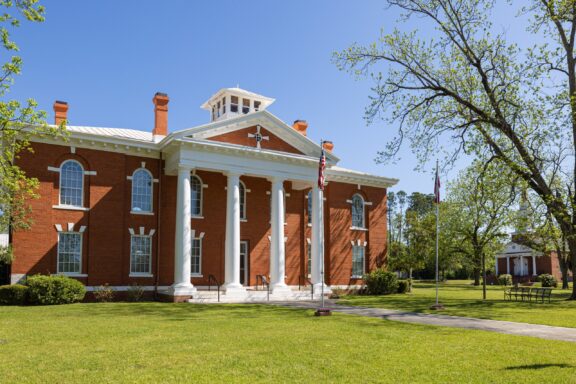 A front view of the Webster County Courthouse facade on a sunny day in Preston, Georgia.