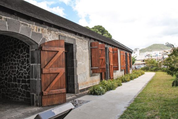 Historic Stone Building with Wooden Doors Aapravasi Ghat, bearing witness to the large-scale indentured labor migration