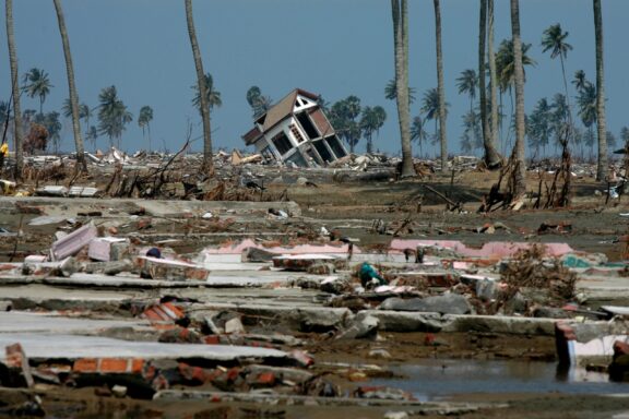 A damaged building stands crooked, surrounded by debris in Banda Ace, Indonesia a few days after the 2004 earthquake and tsunami.