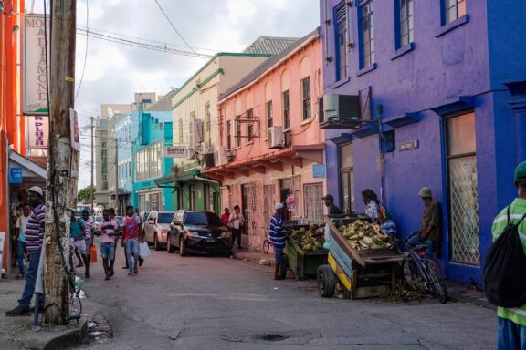 Locals commute through the busy streets lined with colorful houses