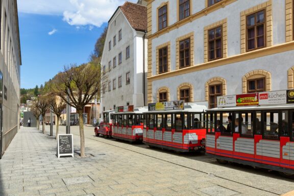 Tram Passing Through Historic City Street City Train Vaduz, a unique way to explore Vaduz