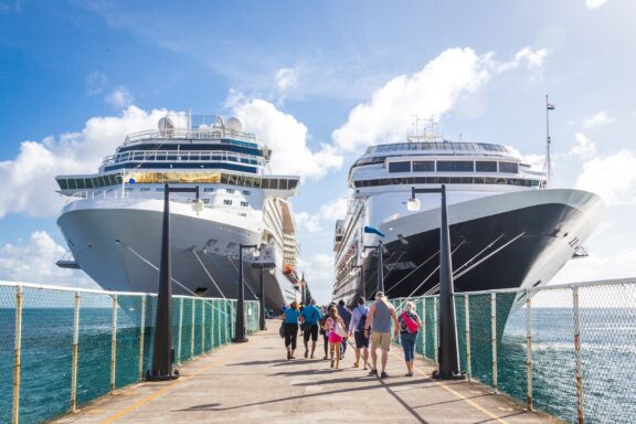 Cruise Ships Docked with Passengers Walking on Pier Cruise ships docking at Basseterre