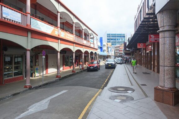 Urban Street Scene with Cars and Pedestrians Cumming Street, a historical street named after early Fijian trader John Cumming