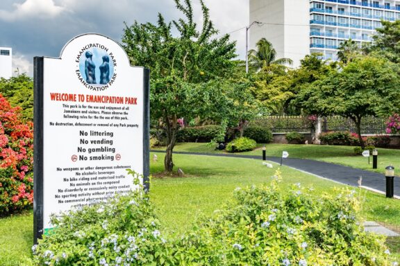 Welcome Sign at Emancipation Park Entrance with Greenery Emancipation Park, inaugurated in 2002 to commemorate the end of slavery in Jamaica