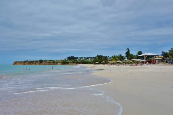 Tropical Beach with Gentle Waves and Blue Sky Fort James Beach, known for its stunning views and historical significance