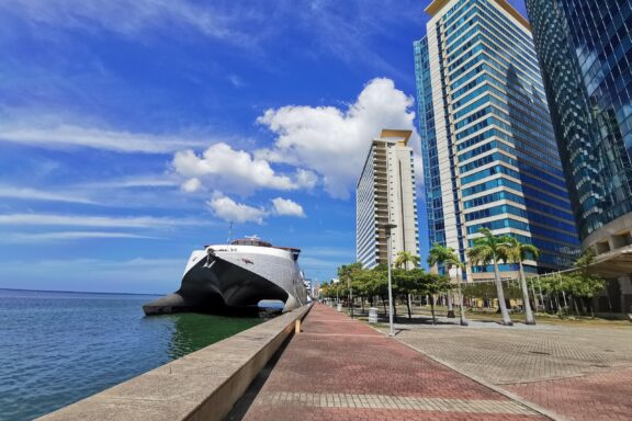 Waterfront with Modern Buildings and Moored Ship International Waterfront Complex, a hub for business and trade