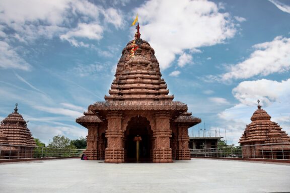 A view of the front of Jagannath Temple under a partly cloudy sky in Dibrugarh, Assam, India.