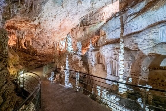 Walkway Inside Jeita Grotto with Stalactites and Stalagmites Jeita Grotto Cave, featuring two separate but interconnected, limestone caves