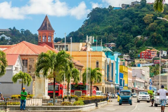 Tropical City Street Scene with Colorful Buildings and Hillside The lively city center of Kingstown