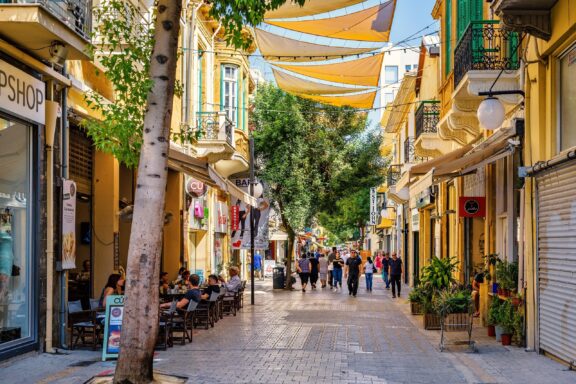Bustling Pedestrian Street with Shops and Cafés Pedestrians stroll through Ledra Street, the main shopping street