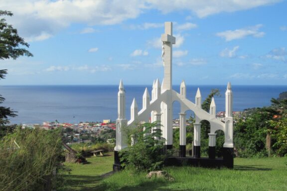 Cross Monument Overlooking Coastal Town The Morne Bruce Cross, standing as a significant spiritual symbol for the community