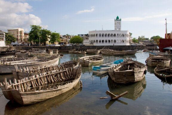 Boats and Mosque by the Waterfront Wrecked boats near Moroni with the old Friday Mosque in the background