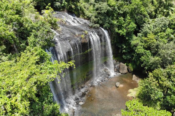 Tropical Waterfall Amidst Green Foliage Ngardmau Waterfall, the largest waterfall in Palau