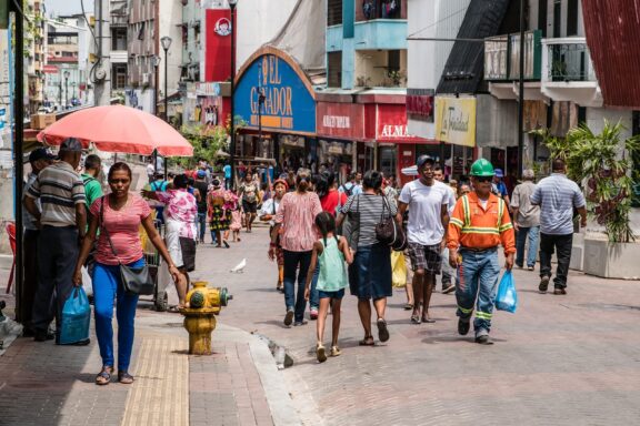 Pedestrians Walking on a Busy Street in Panama City Locals commuting on pedestrian-only street in Panama City, melding traditional lifestyles with modern urban planning