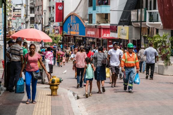 Locals commuting on pedestrian-only street in Panama City, melding traditional lifestyles with modern urban planning