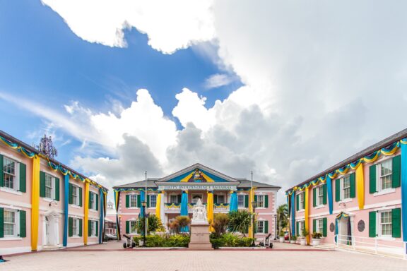 Colorful Buildings Around a Square with Statue Parliament Square, a colonial-style building in the governmental heart of the Bahamas