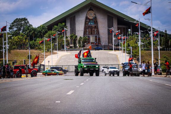 Old Parliament House in Port Moresby with People and Vehicles Locals celebrating independence day at the Port Moresby Parliament