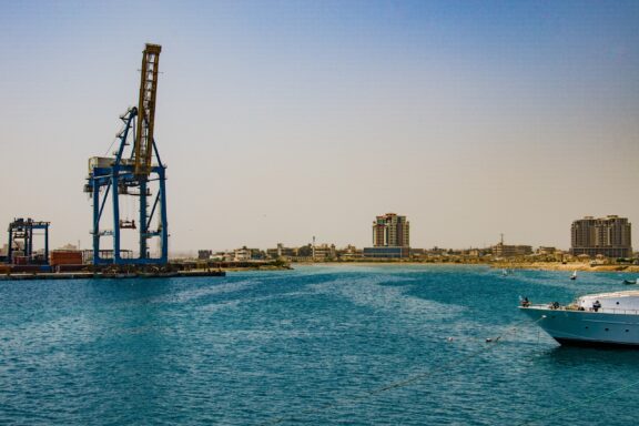 A crane hangs over the water in Port Sudan.