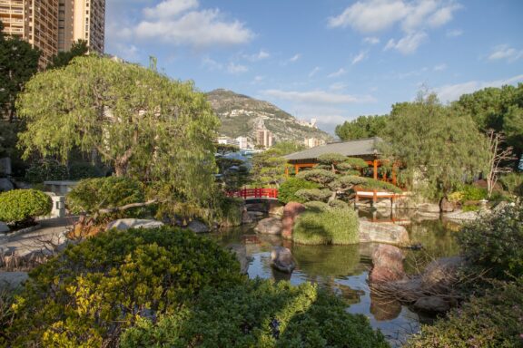 Japanese Garden with Red Bridge and Lush Greenery Princess Grace Japanese Garden, created in 1994, to honor the late Princess Grace of Monaco