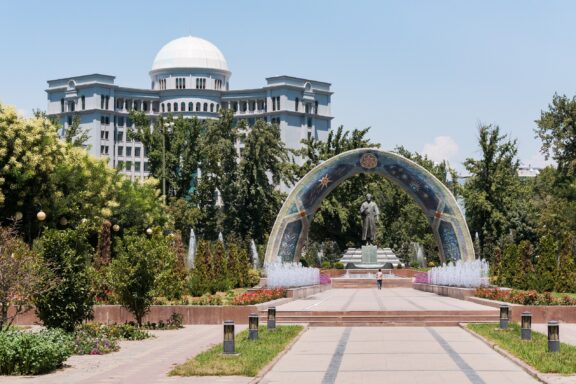 Park Pathway Leading to a Decorative Arch and Building Rudaki Park, named after the celebrated Persian poet Rudaki