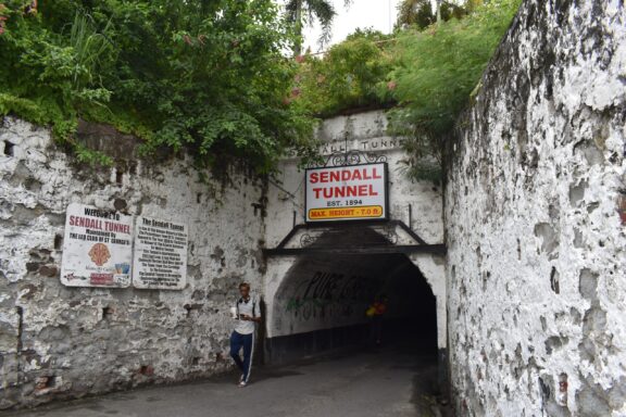 Person Standing by the Entrance of Sendall Tunnel Sendall Tunnel, a historical 19th-century tunnel