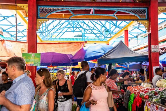Bustling Market Scene with Colorful Stalls and Shoppers Crowds at Sir Selwyn Selwyn-Clarke Market