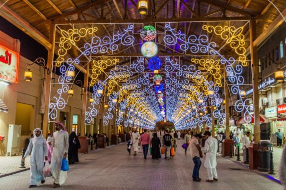 Evening at Souq Al-Mubarakiya with Illuminated Decorations People meander through Souq Al-Mubarakiya