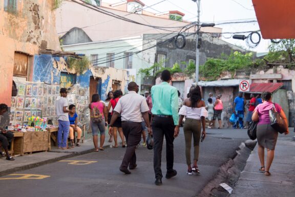 Street Scene with Locals and Vendors Locals commute on the bustling streets of St. George's