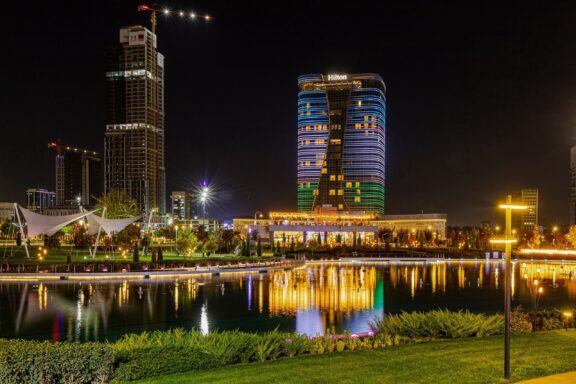 Night View of Tashkent City Center with Illuminated Buildings Reflecting on Water Tashkent New City Center, a modern development featuring state-of-the-art architecture
