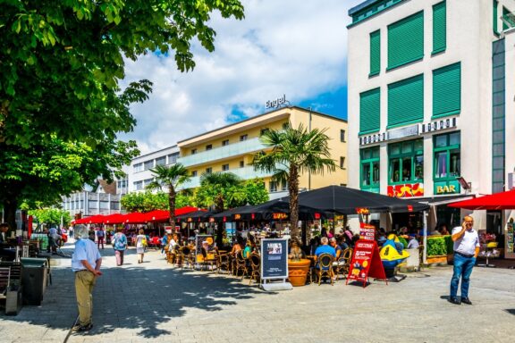 Pedestrians and Outdoor Cafes in Vaduz City Center Locals wander around the lively streets of Vaduz