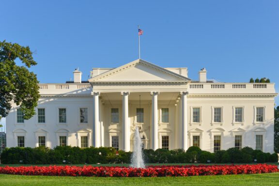 The White House Facade with Fountain and Flowers The White House, serving as the official residence of U.S. Presidents since John Adams in 1800