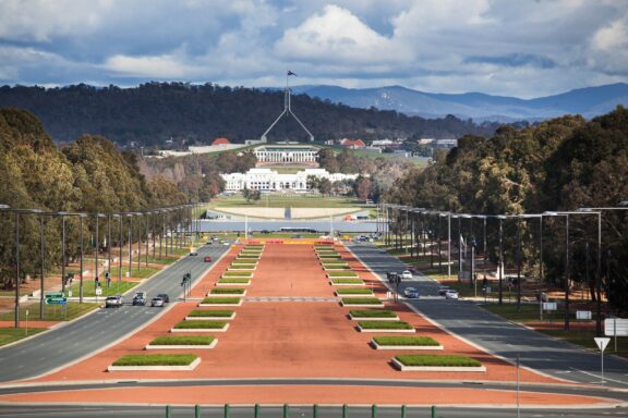 View of the Australian Parliament House from Anzac Parade in Canberra, Australian Capital Territory A view of Canberra’s Capital Hill from a distance in the Australian Capital Territory.