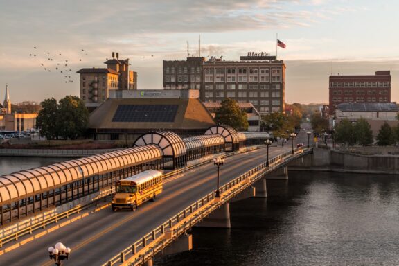 A bridge crosses the Cedar River in Waterloo, Iowa at dusk.