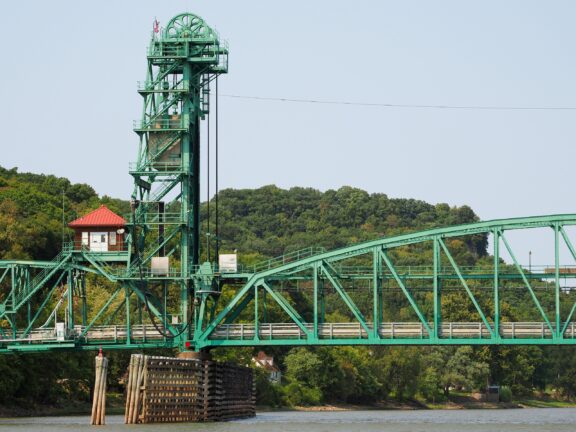 A view of the green Joe Page Bridge extending over the Illinois River.