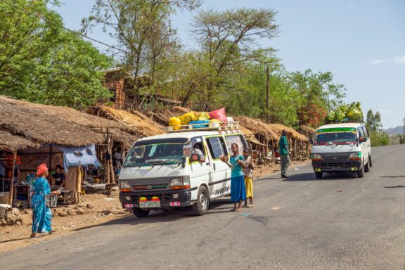 People gather around a van loaded with goods in Welikte, Ethiopia.