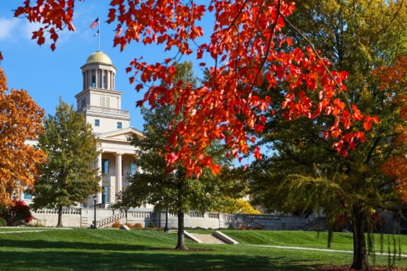 A view of the Old Capitol Museum through trees on the campus of the University of Iowa.