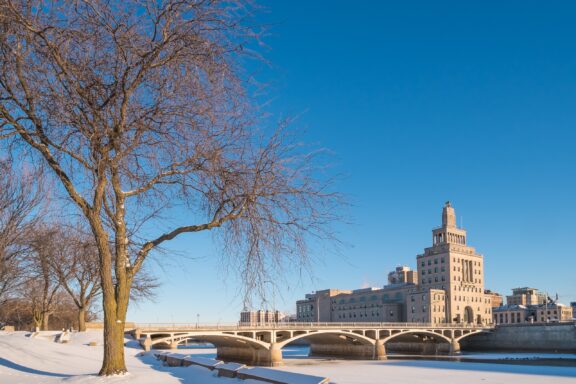 A view of Cedar Rapids City Hall on a clear day with snow on the ground.