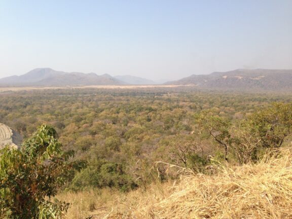 A view of arid grasslands extending to hills in the distance near Assosa, Ethiopia.