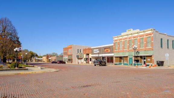 A street-level view of shops lining the road in Mount Ayr, Iowa.