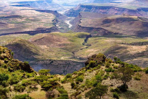 A view of a sprawling landscape with a mostly dry river bed at the bottom of a large canyon in the Somali Region of Ethiopia.