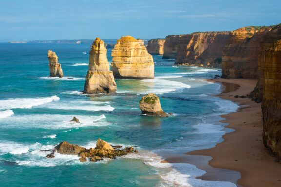 Morning Light Bathing the Twelve Apostles on the Great Ocean Road, South Australia A view of waves reaching the shore among the Twelve Apostles rock formation in South Australia.
