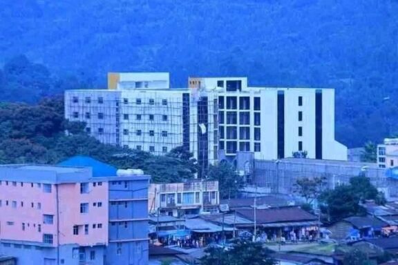 A view of buildings backed by hills in a blue light in Mizan Teferi, Ethiopia.