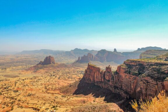 An aerial view of a vast golden landscape and dramatic cliffs in Ethiopia’s Tigray Region.