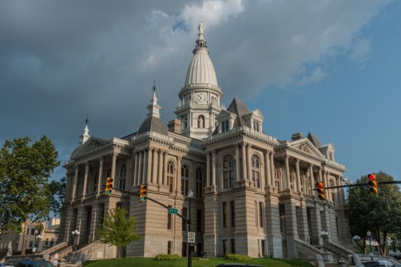 A low-angle view of the Tippecanoe County Courthouse under a cloudy sky.