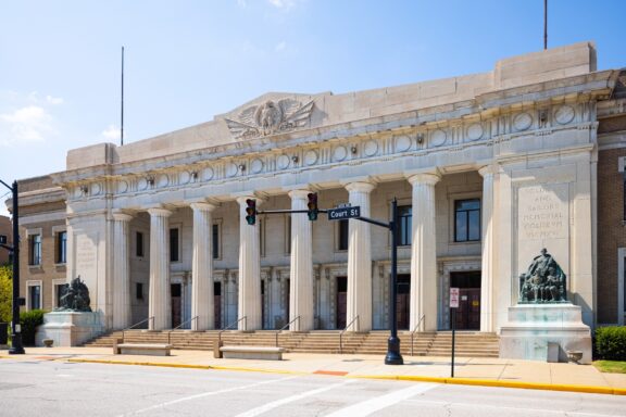 A street-level view of the memorial facade on a clear day in Evansville, Indiana.