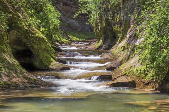 Water cascades over rocks in Warren County’s Fall Creek Gorge Nature Preserve.