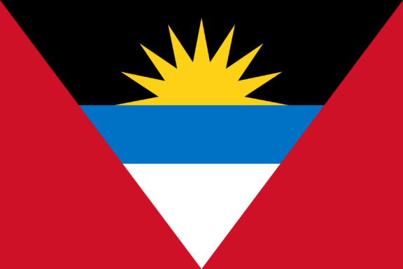 Flag of Antigua and Barbuda with horizontal bands of black, blue, and white, with a red triangle and a yellow sun.