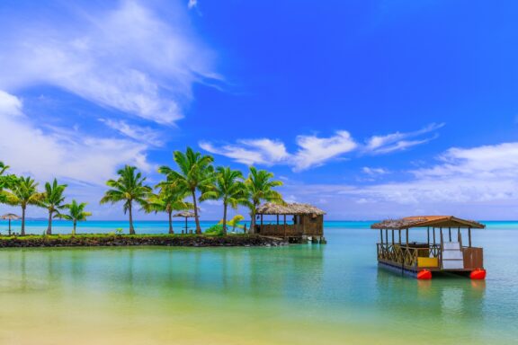 Tropical Resort with Overwater Bungalows and Palm Trees Traditional Samoa hut and boat near Apia